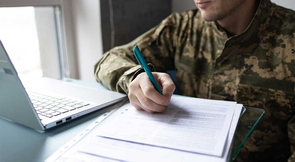 veteran filling out the form highlights the first step in filing a VA claim for lupus and other autoimmune diseases.